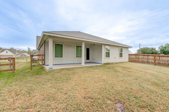 back of house with a yard and a patio area