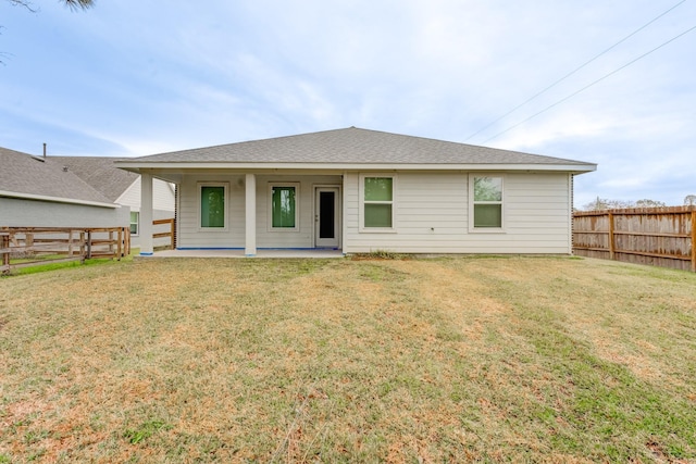 rear view of house featuring a lawn and a patio area