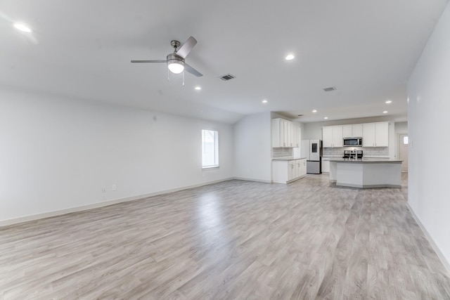 unfurnished living room featuring light hardwood / wood-style flooring and ceiling fan