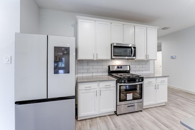 kitchen featuring white cabinetry, appliances with stainless steel finishes, and light wood-type flooring