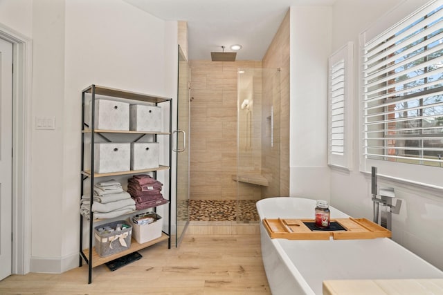 bathroom with separate shower and tub and hardwood / wood-style floors