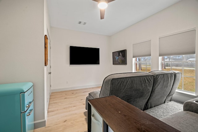 living room with ceiling fan, a wealth of natural light, and light hardwood / wood-style floors