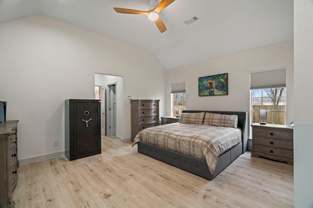 bedroom with multiple windows, vaulted ceiling, and light hardwood / wood-style floors