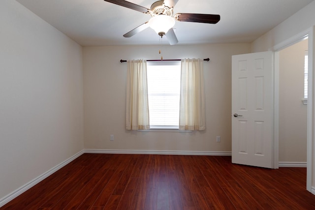 spare room with a ceiling fan, wood finished floors, and baseboards