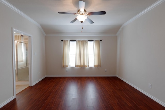 spare room featuring a ceiling fan, crown molding, wood finished floors, and baseboards