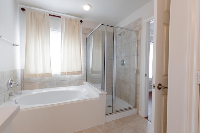 full bath with tile patterned floors, a shower stall, and a garden tub