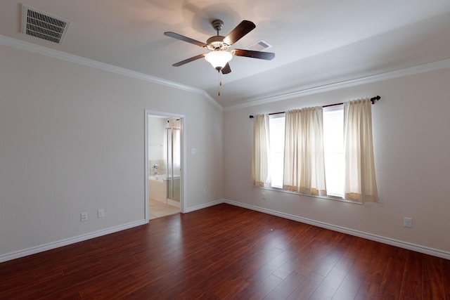 empty room featuring visible vents, baseboards, wood finished floors, and crown molding