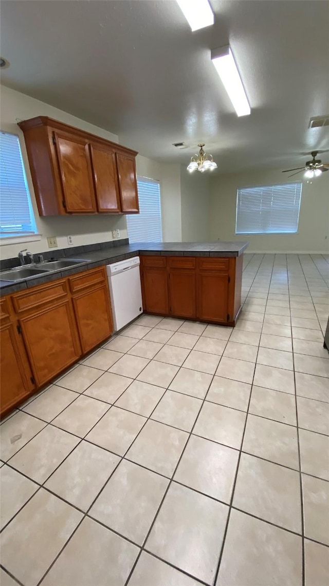 kitchen with white dishwasher, sink, light tile patterned floors, and ceiling fan