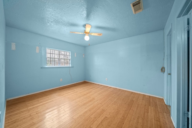 spare room featuring ceiling fan, a textured ceiling, and light hardwood / wood-style floors