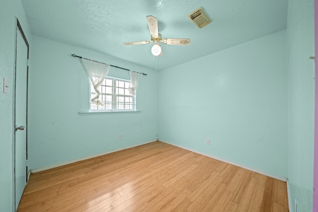 unfurnished bedroom with ceiling fan, a textured ceiling, and light wood-type flooring