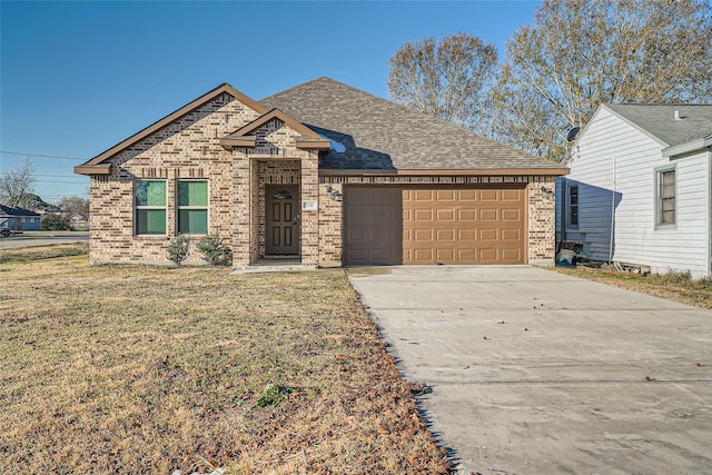 view of front of home featuring a garage and a front lawn