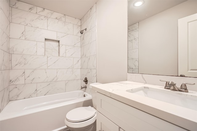 full bathroom with vanity, tiled shower / bath combo, and toilet