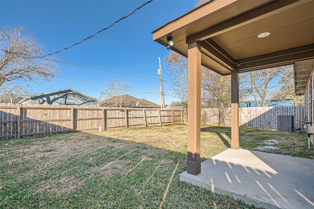 view of yard with central AC and a patio area