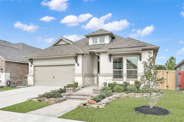 view of front of property featuring a garage and a front yard