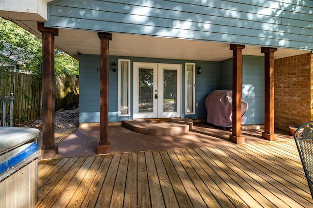 wooden terrace with area for grilling and french doors