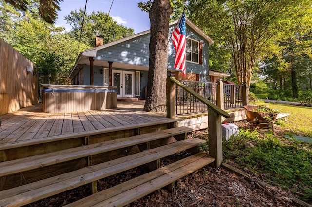 deck with french doors and a hot tub