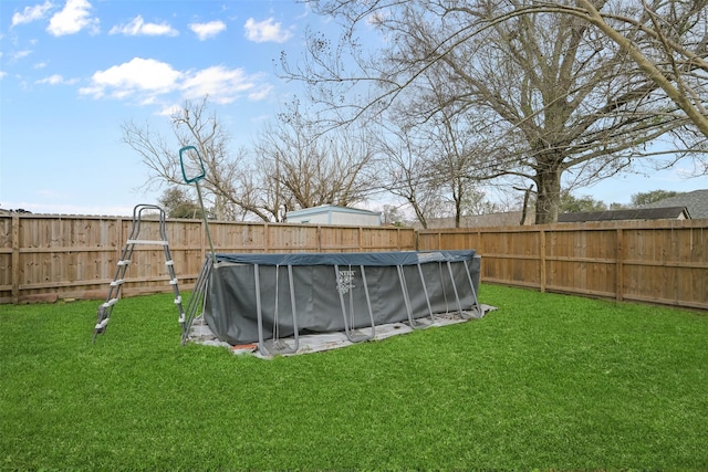 view of yard with a covered pool