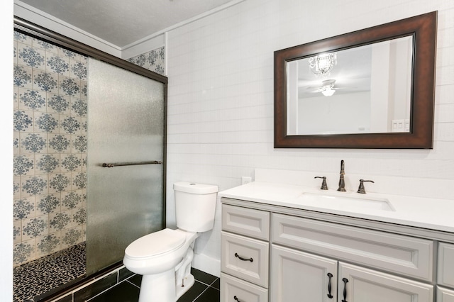 bathroom featuring tile patterned floors, toilet, vanity, and an enclosed shower