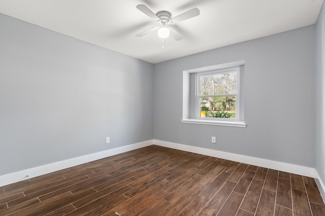 spare room featuring dark hardwood / wood-style floors and ceiling fan