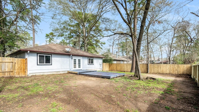 rear view of house with french doors and a deck