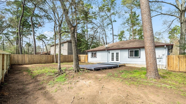 rear view of house with french doors and a deck