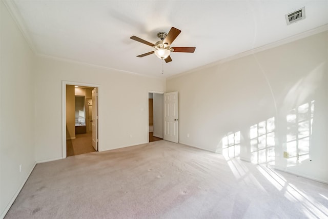 unfurnished bedroom featuring crown molding, connected bathroom, light colored carpet, and ceiling fan