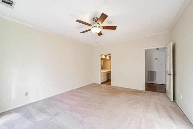 unfurnished bedroom featuring light carpet, ensuite bath, ornamental molding, and ceiling fan