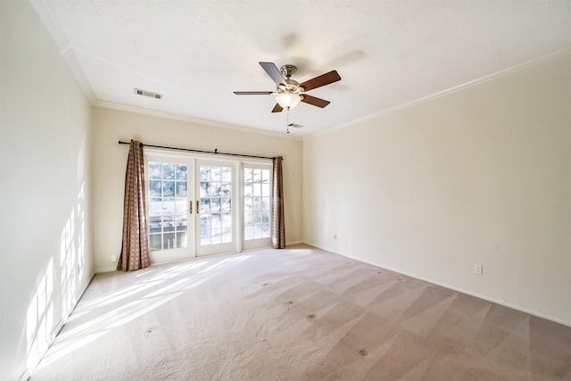 empty room with crown molding, light carpet, and ceiling fan