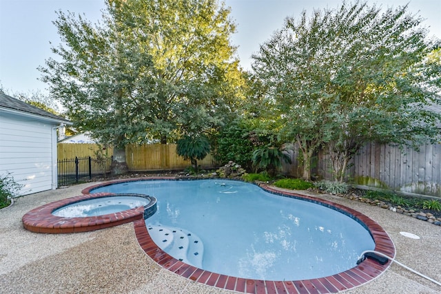 view of pool featuring an in ground hot tub