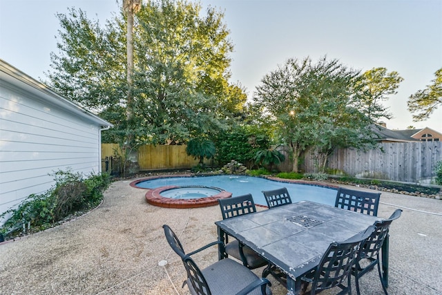 view of patio / terrace featuring an in ground hot tub