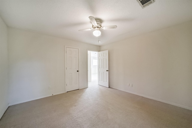 carpeted spare room featuring a textured ceiling and ceiling fan