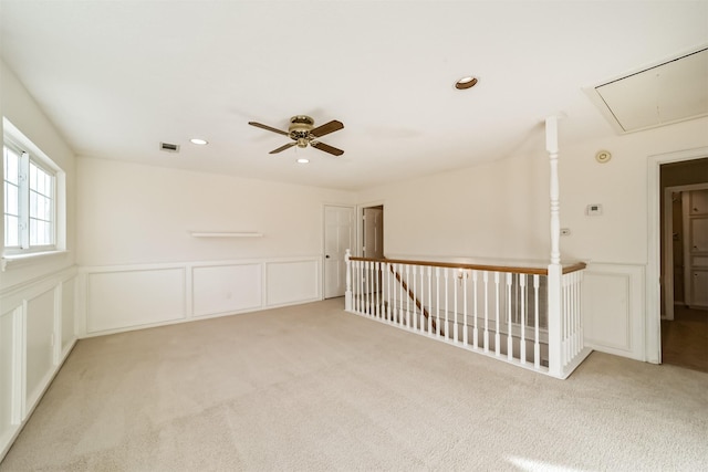 empty room with light colored carpet and ceiling fan