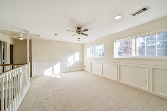 carpeted spare room featuring ceiling fan