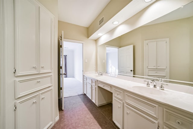 bathroom with tile patterned flooring and vanity