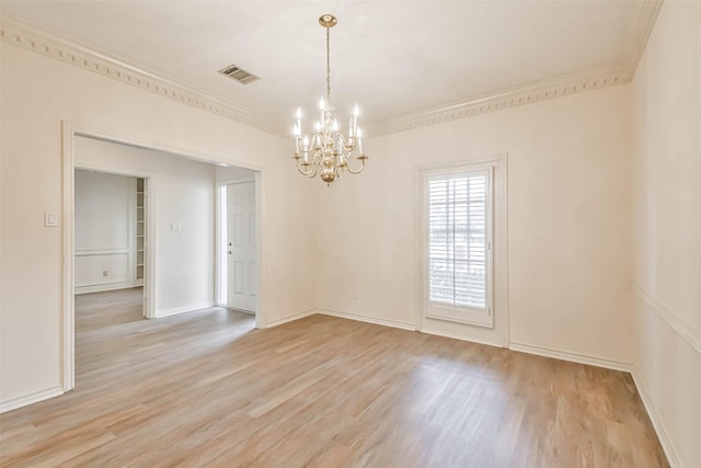 empty room with light hardwood / wood-style flooring, ornamental molding, and a chandelier