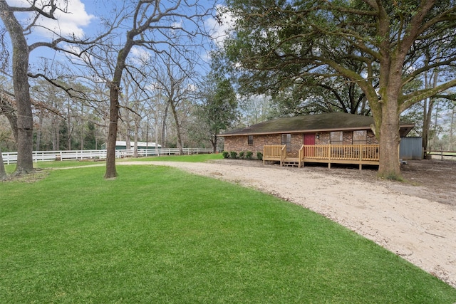 view of yard featuring fence and a wooden deck