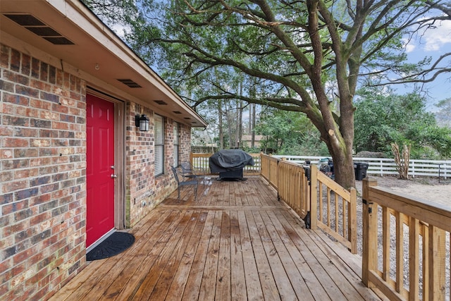 wooden terrace featuring area for grilling