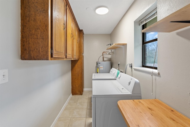 laundry area featuring independent washer and dryer, cabinets, water heater, and light tile patterned floors