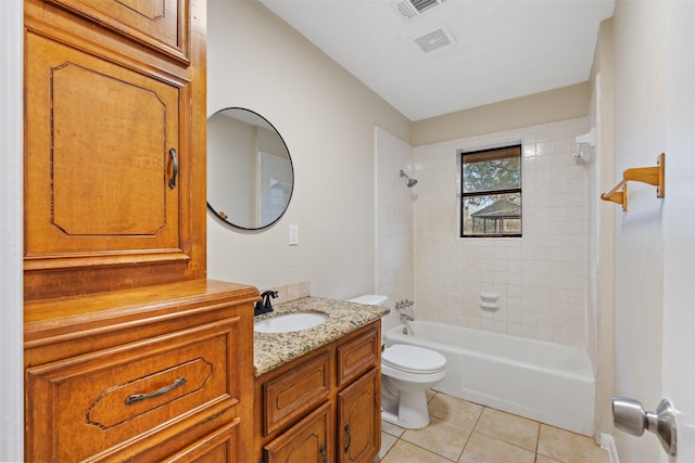 full bathroom featuring tile patterned flooring, vanity, toilet, and tiled shower / bath