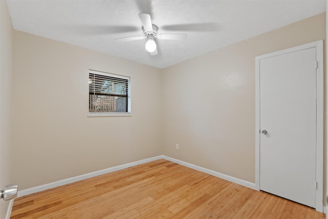 spare room featuring ceiling fan, hardwood / wood-style floors, and a textured ceiling