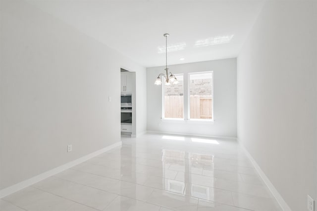 unfurnished dining area featuring a chandelier