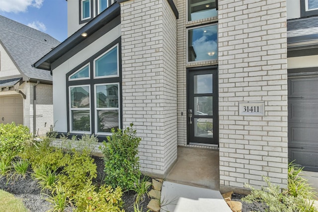 view of exterior entry featuring a garage