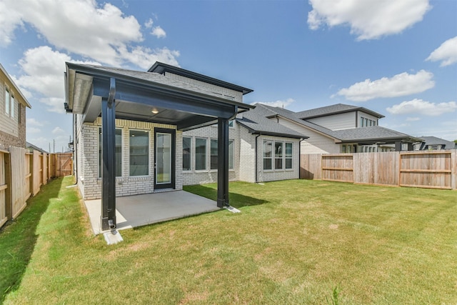 back of house featuring a yard and a patio area