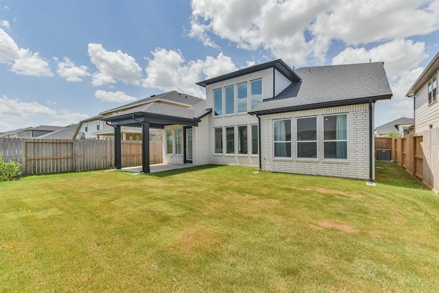 back of property with cooling unit, a yard, and a patio