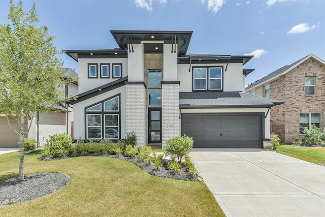 view of front facade with a garage and a front lawn