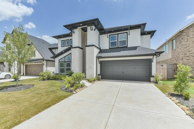 prairie-style house featuring a garage and a front yard