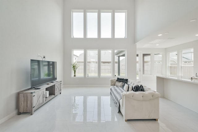 living room featuring a high ceiling and light tile patterned floors