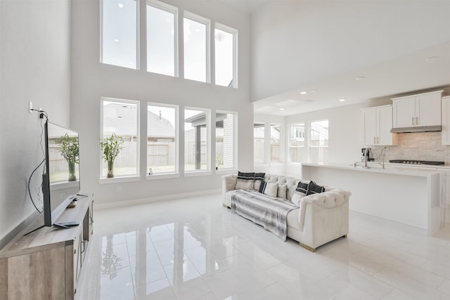 living room with a towering ceiling and a wealth of natural light