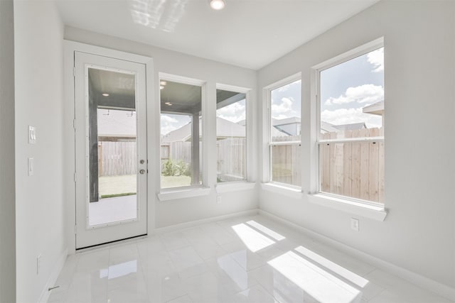 unfurnished sunroom featuring a healthy amount of sunlight