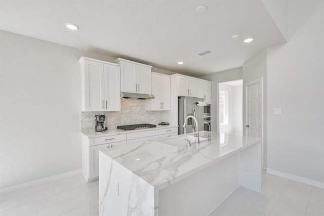 kitchen featuring white cabinetry, an island with sink, appliances with stainless steel finishes, and sink